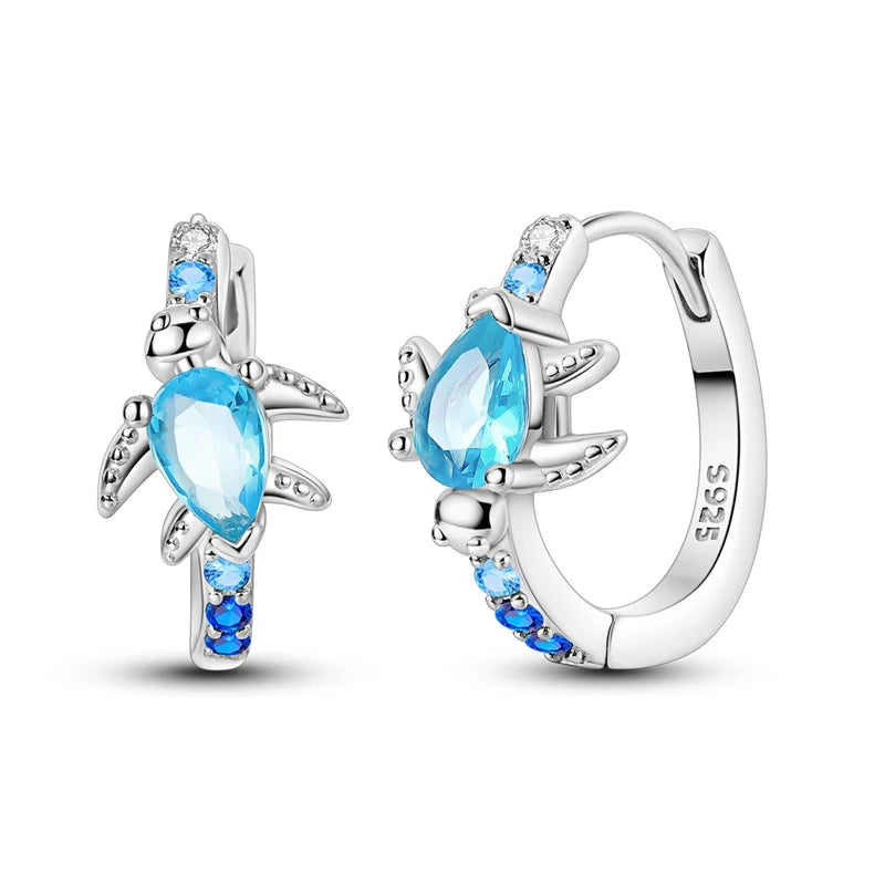 Pair of sterling silver turtle hoop earrings with teardrop-shaped blue stones